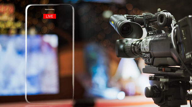 Video camera taking live video streaming with lighting frame of mobile phone and Live text at meeting room.