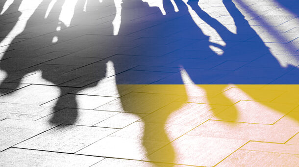Schatten von Menschen auf Asphalt, eingefärbt in den Farben der Ukraine blau und gelb
