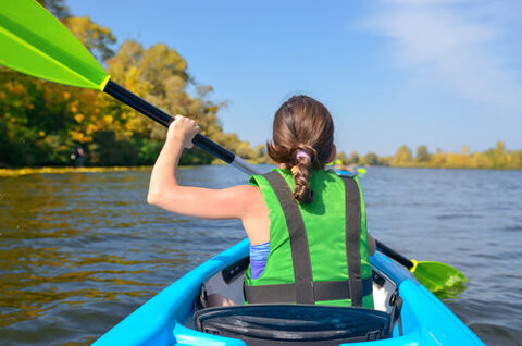 Family kayaking, child paddling in kayak on river canoe tour, kid on active summer weekend and vacation, sport and fitness concept