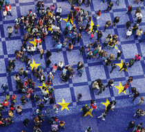 Aufsicht auf mit Menschen gefüllten Platz gepflastert im Stil der Europaflagge