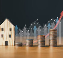 real estate investing and saving money concept.coins stack with house icon and background.