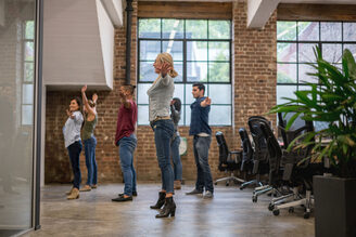 Group of workers exercising at the office