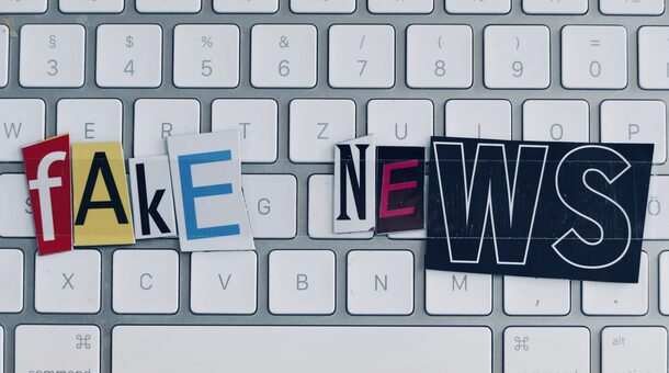 Fake news text on white keyboard
