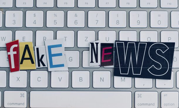 Fake news text on white keyboard